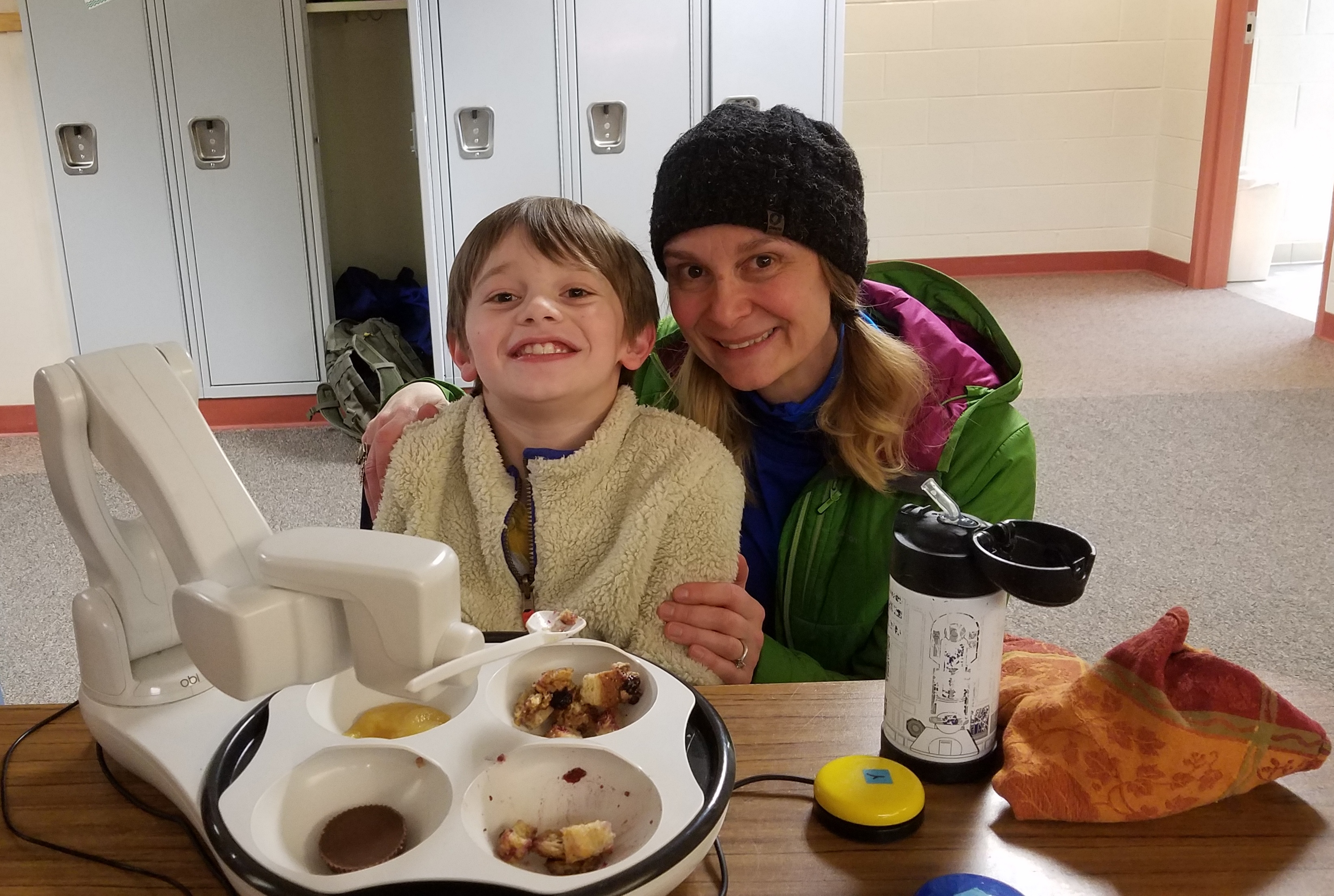 A boy with his mother smiling 