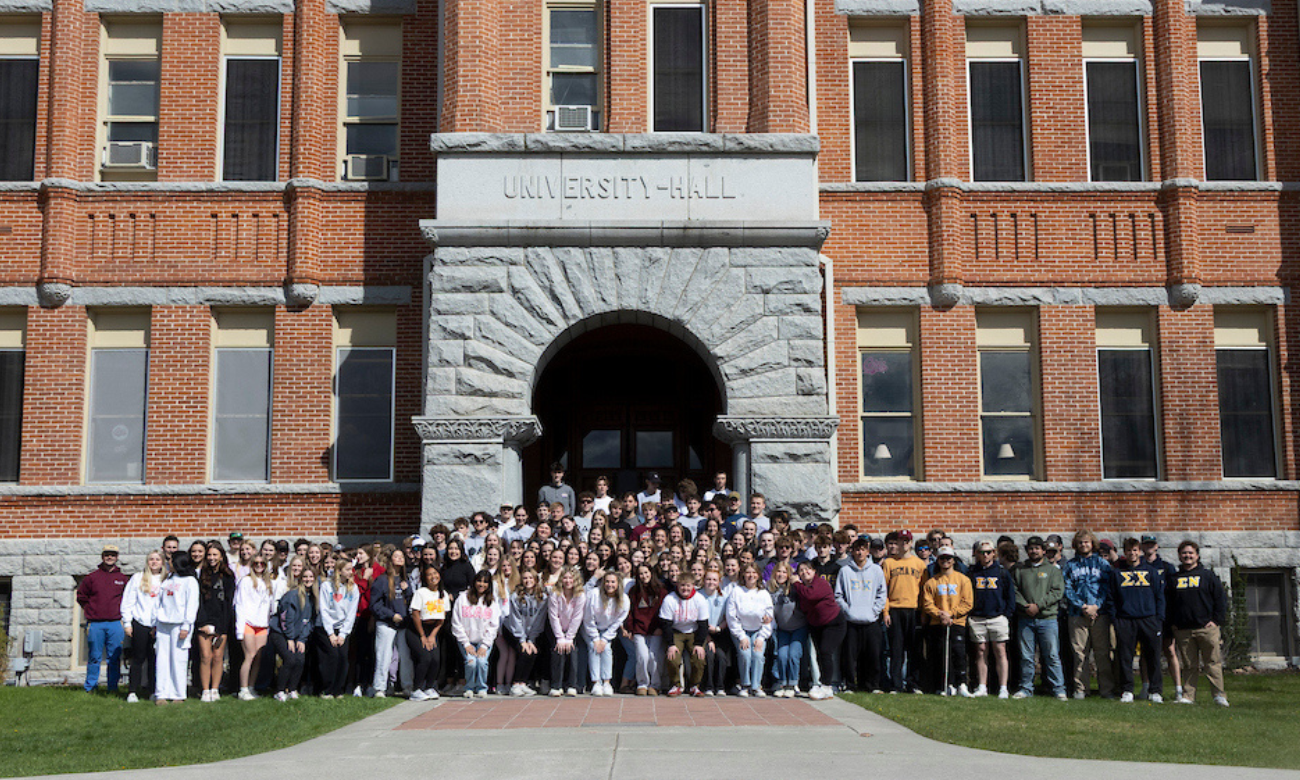 2025 Greek Week Photo featuring large group of students posing on the steps outside University Hall.