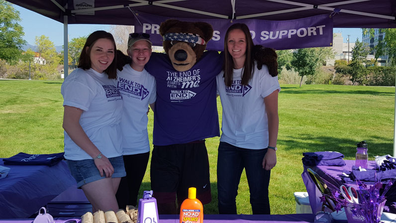 UMGS members and Monte the bear help at the merchandise table