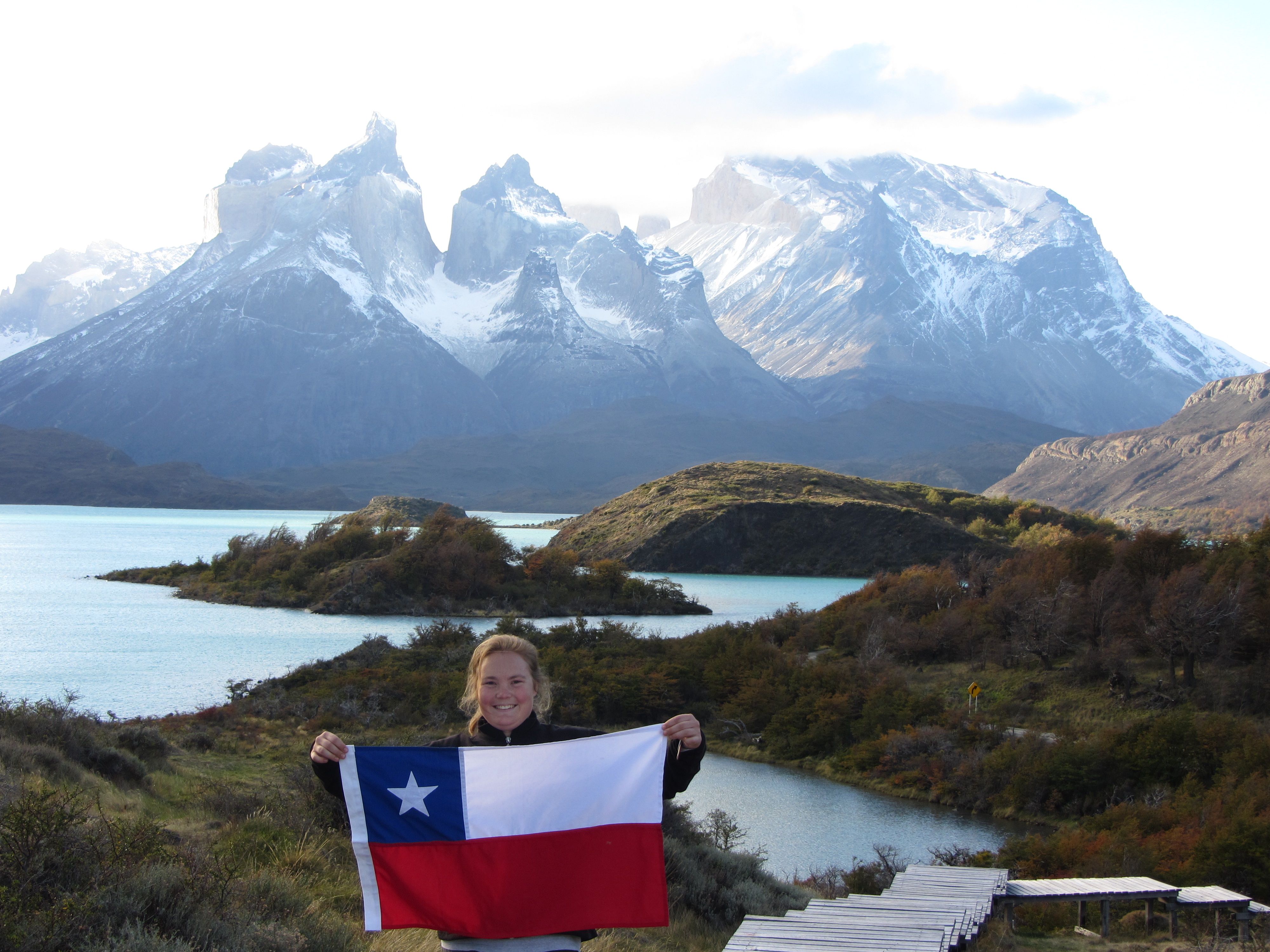 A student holding a flag in South America