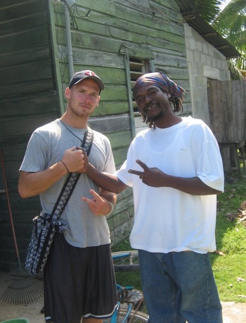Male student posing with man and holding up peace signs
