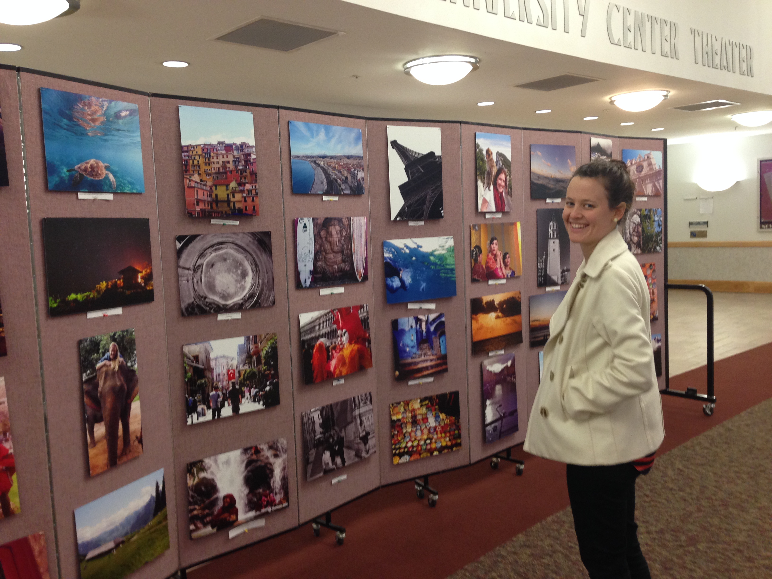 person looking at photos outside of the UC theater on the UM campus