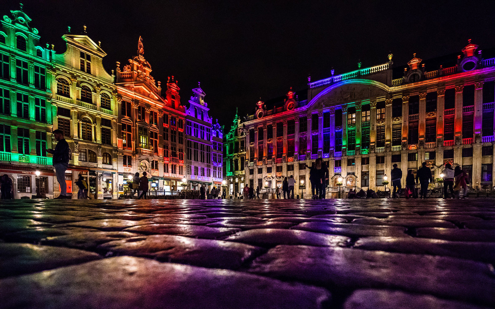 palace lit by rainbow lights at night