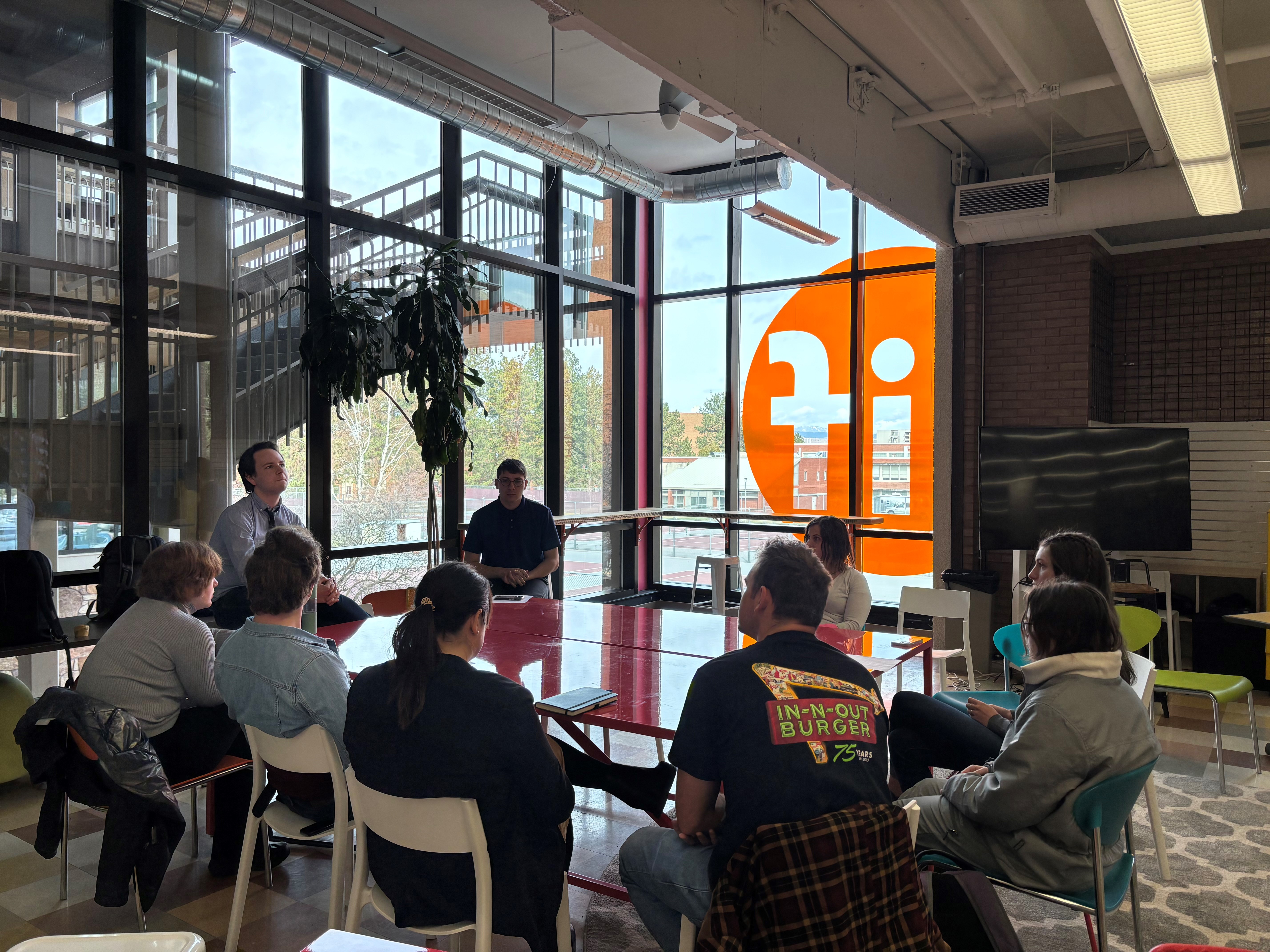 Students sit around a table discussing democracy