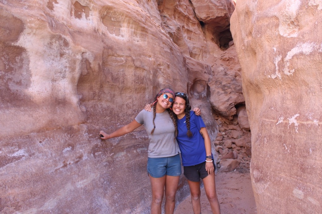 Two female students standing in a cavern in CO