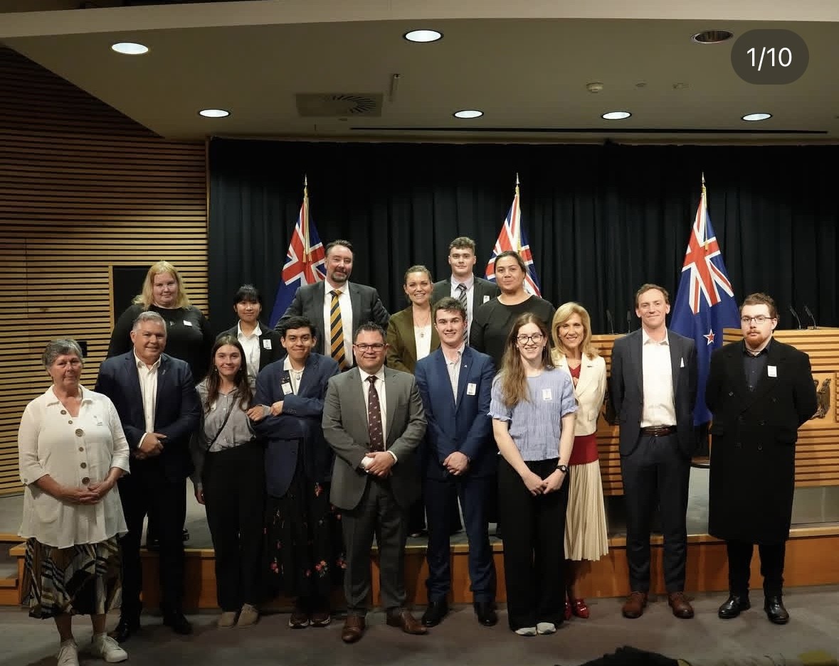 Female student stands with New Zealand parliament leaders