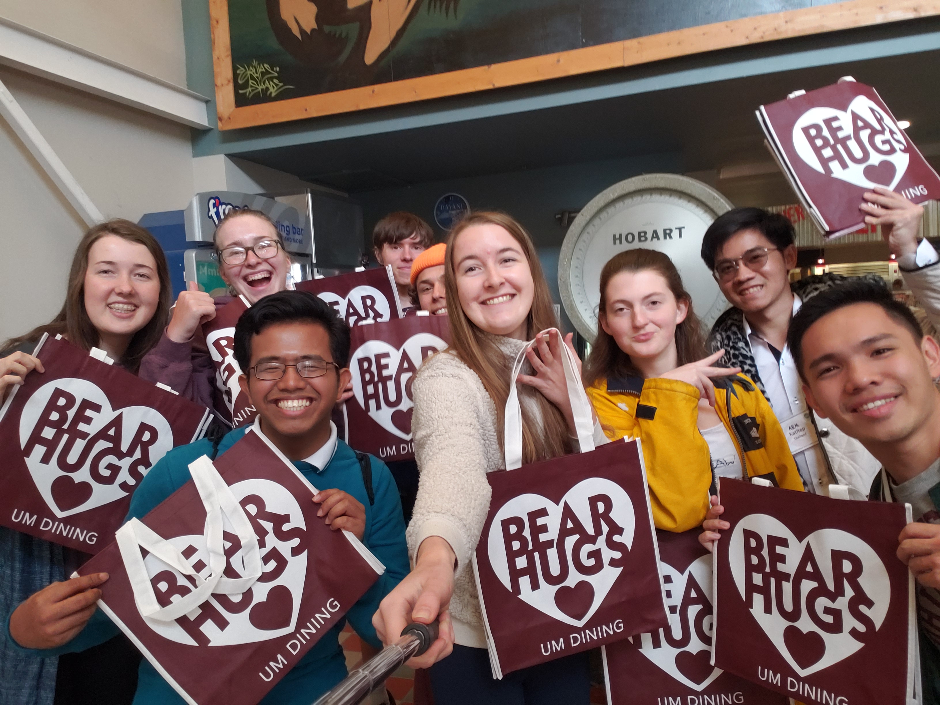 students celebrating with graduation signs