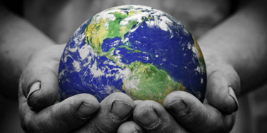 illustration of hands in black and white holding the globe in color