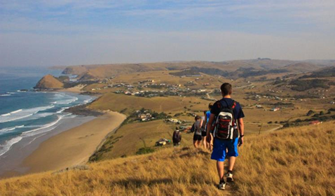 Students walk down a South African coastal hill