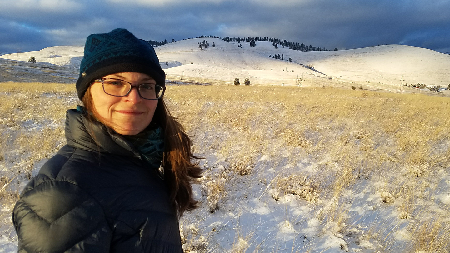 Portrait of Rebekah Skoog standing in a snowy field.