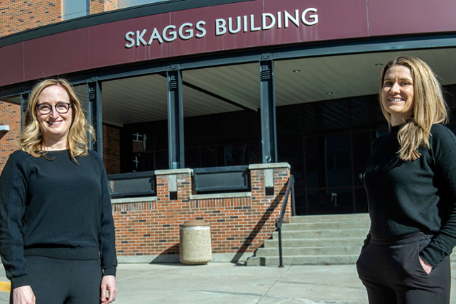 Erica Woodahl and Hayley Blackburn post out front of Skaggs Building at University of Montana