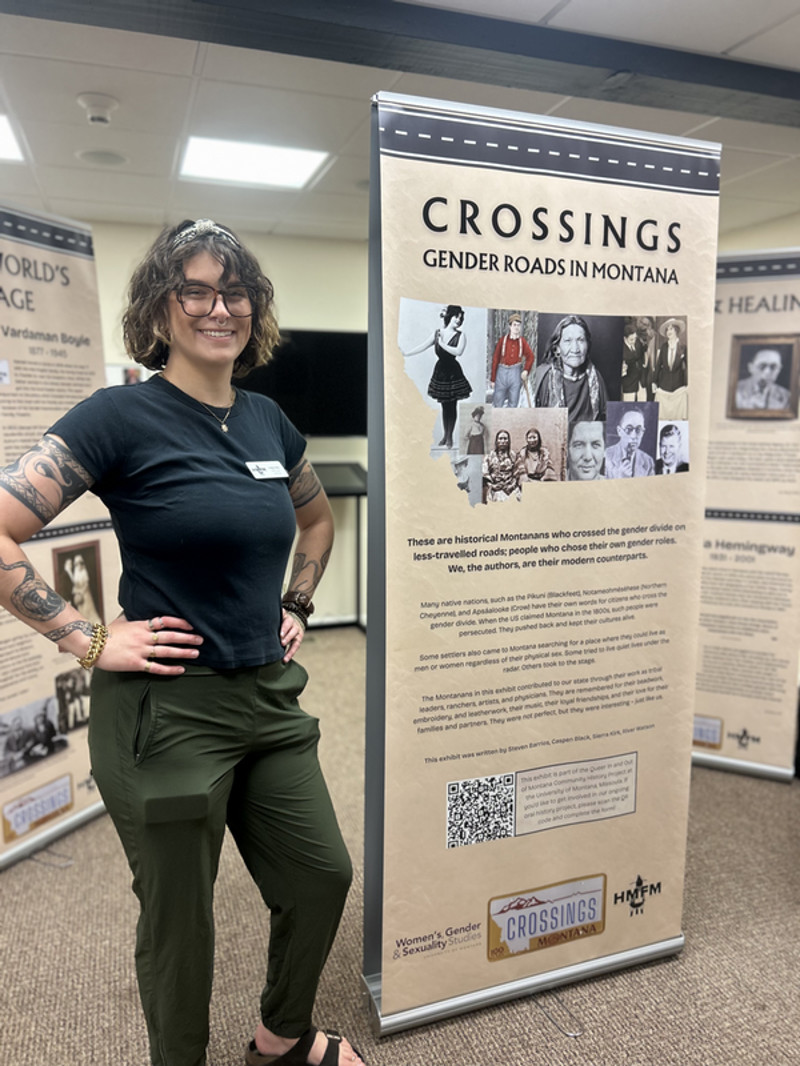 Indy Standing in front of informational displays