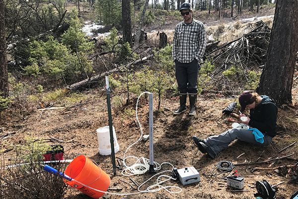 sampling water on a hillslope