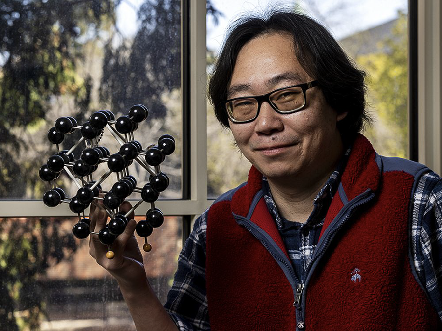 Dong Wang, a male chemist at UM, poses in his lab for a portrait.