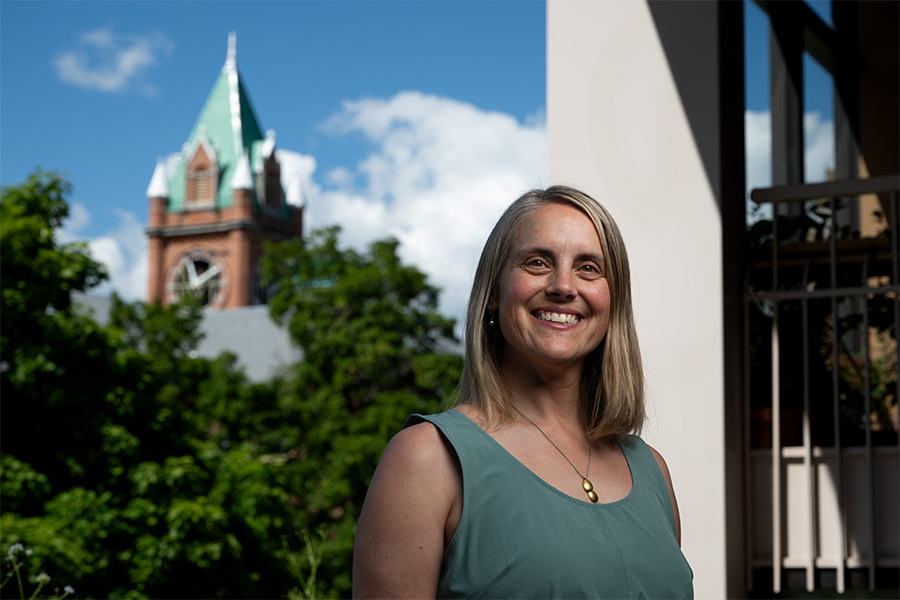 Rachel Severson smiling for the camera with Main Hall in the background