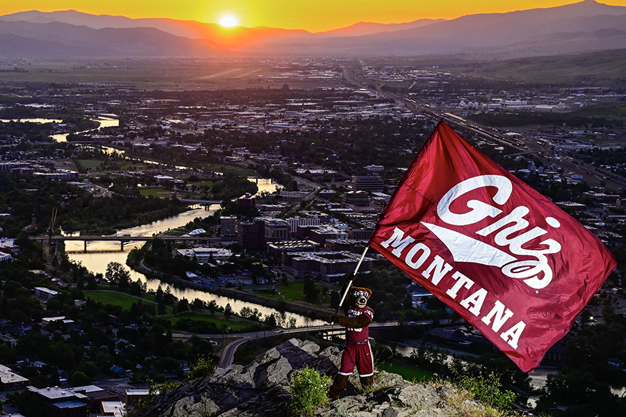 Monte flies a Griz glad on the top of Mt. Sentinel 