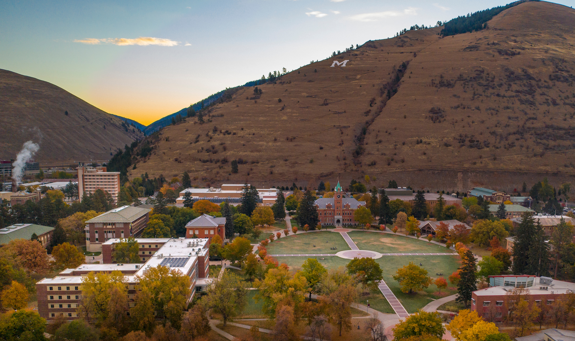 view of UM campus from above with Mount Sentinel and the M trail in the background