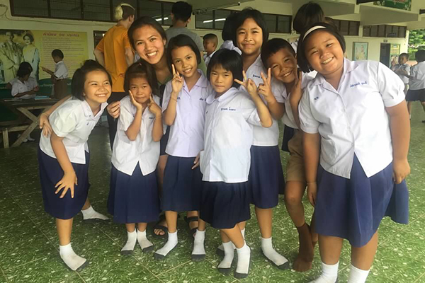 a group of girls standing together in a classroom