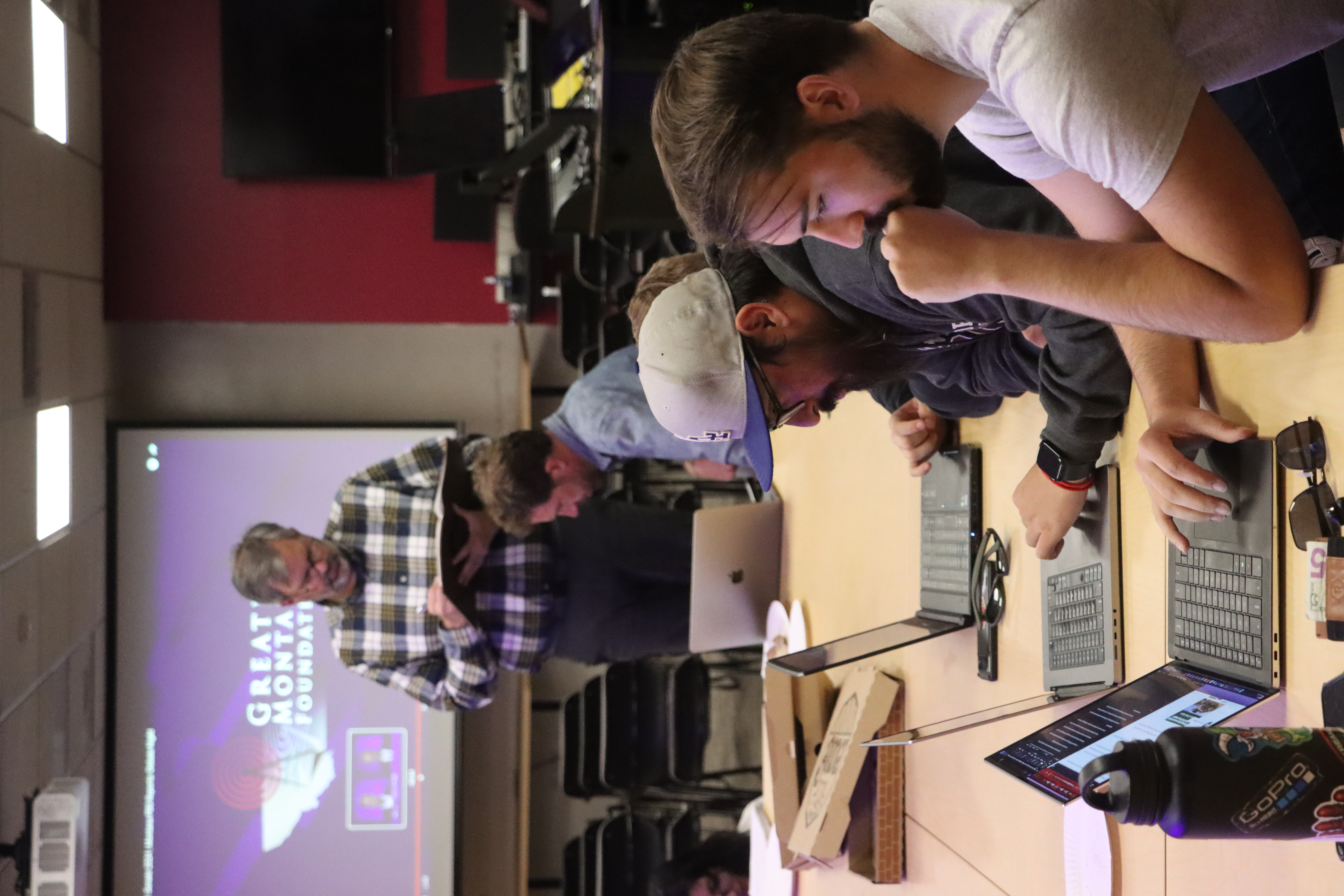 Professors Lee Banville and Jacob Baynham work with students in Election Reporting