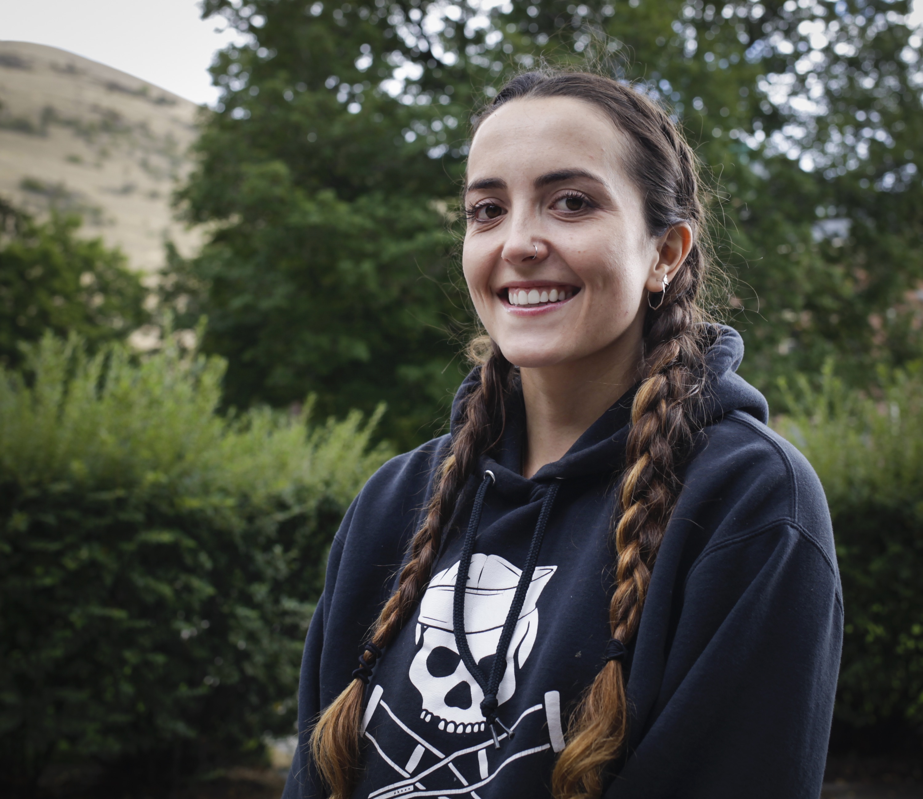 Gentry Hale looking at camera in front of green background.