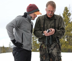 Tom Kuglin shows two men searching for wolverines in the snow