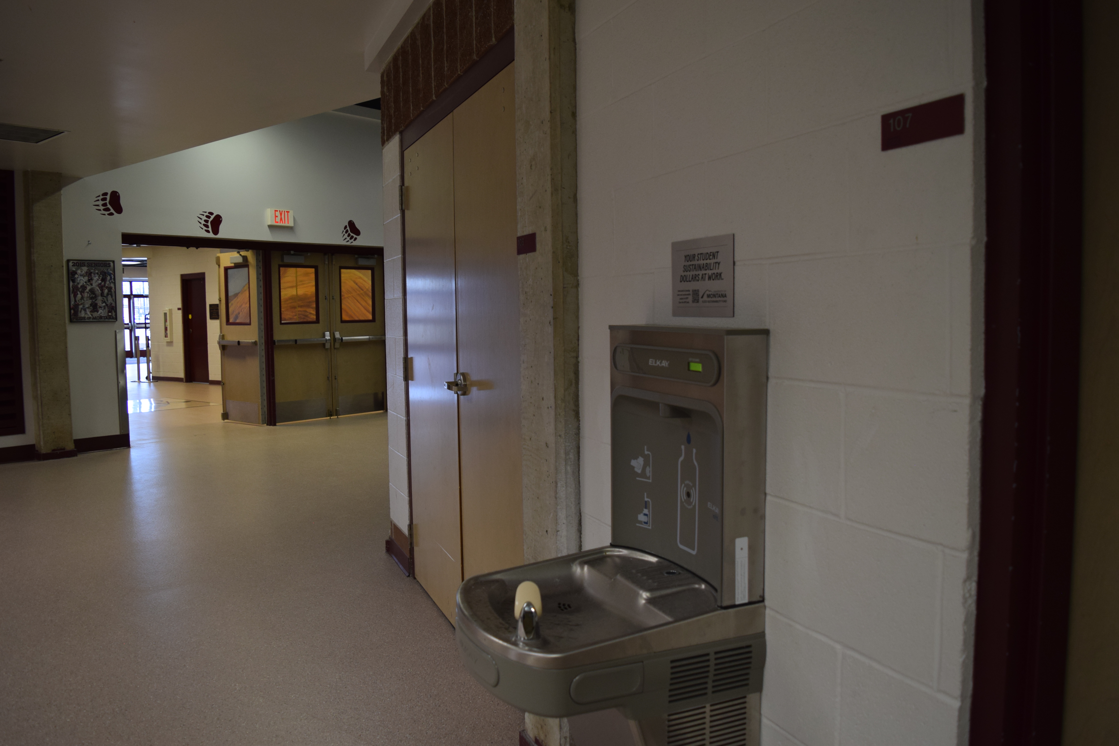 Hallway with a water fountain and bottle-filling station mounted on the wall in Adams Center.