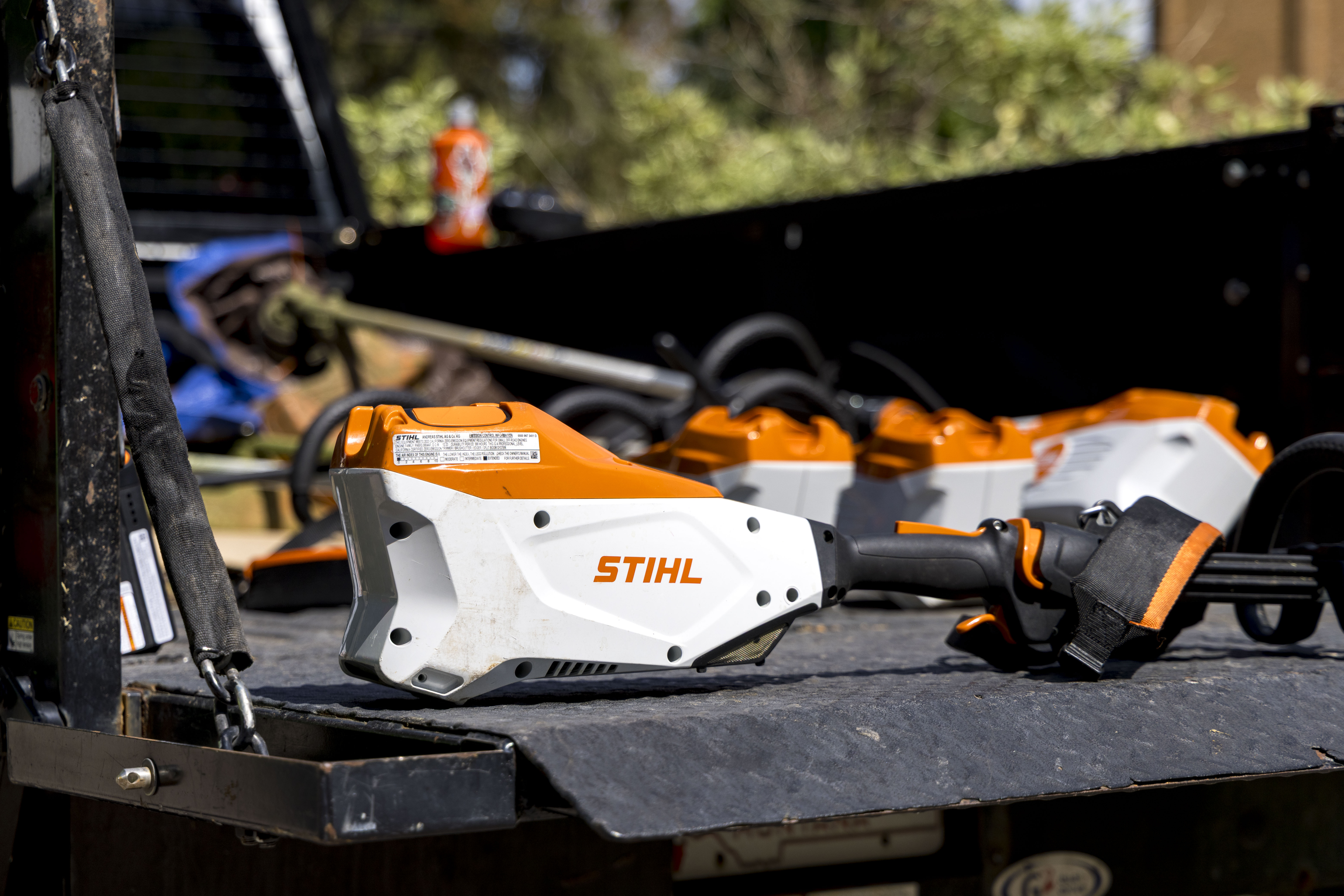 Stihl electric trimmers sitting in a UM Grounds truck
