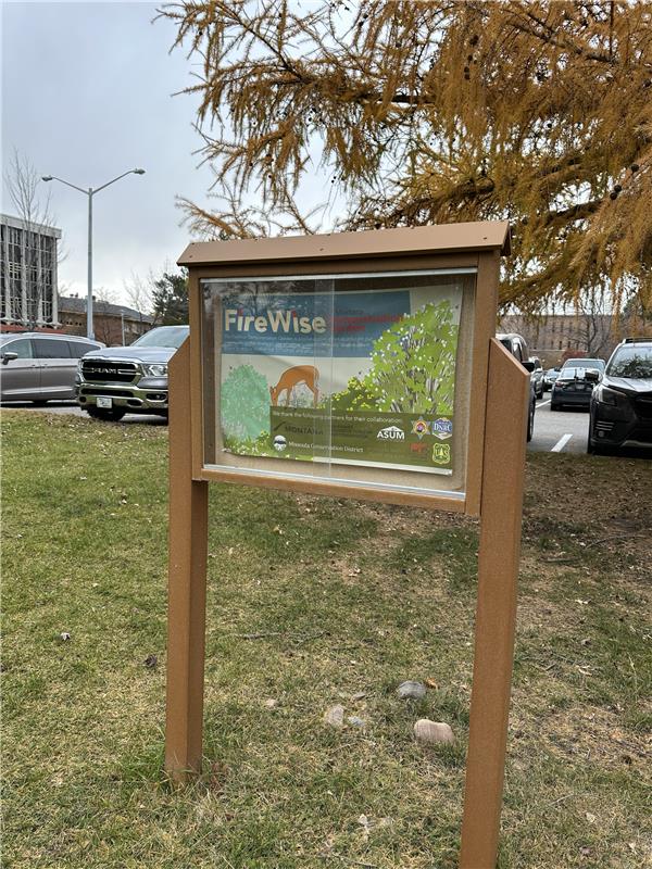 a single sign with information on it for the firewise garden on UM's campus