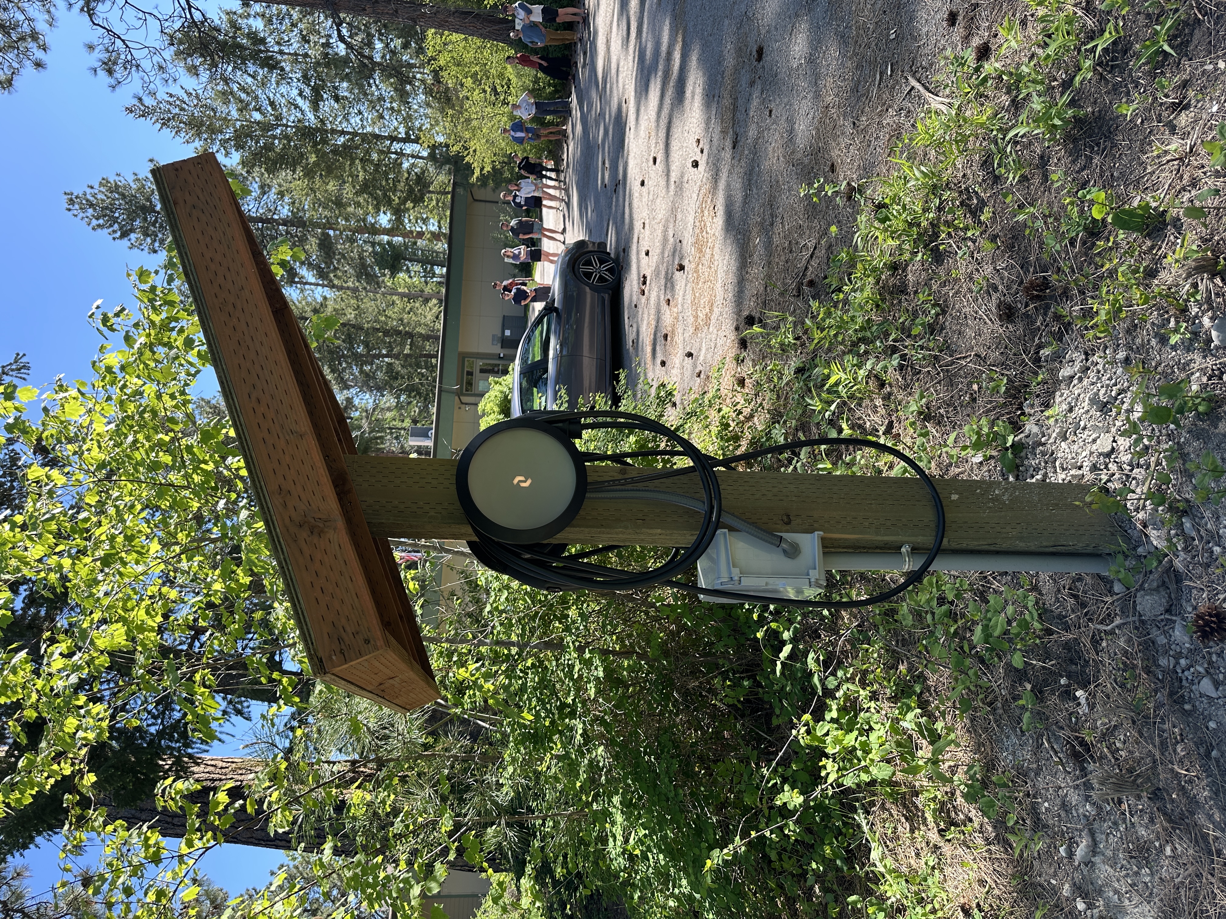electric vehicle charger surrounded by forest at the flathead lake bio station