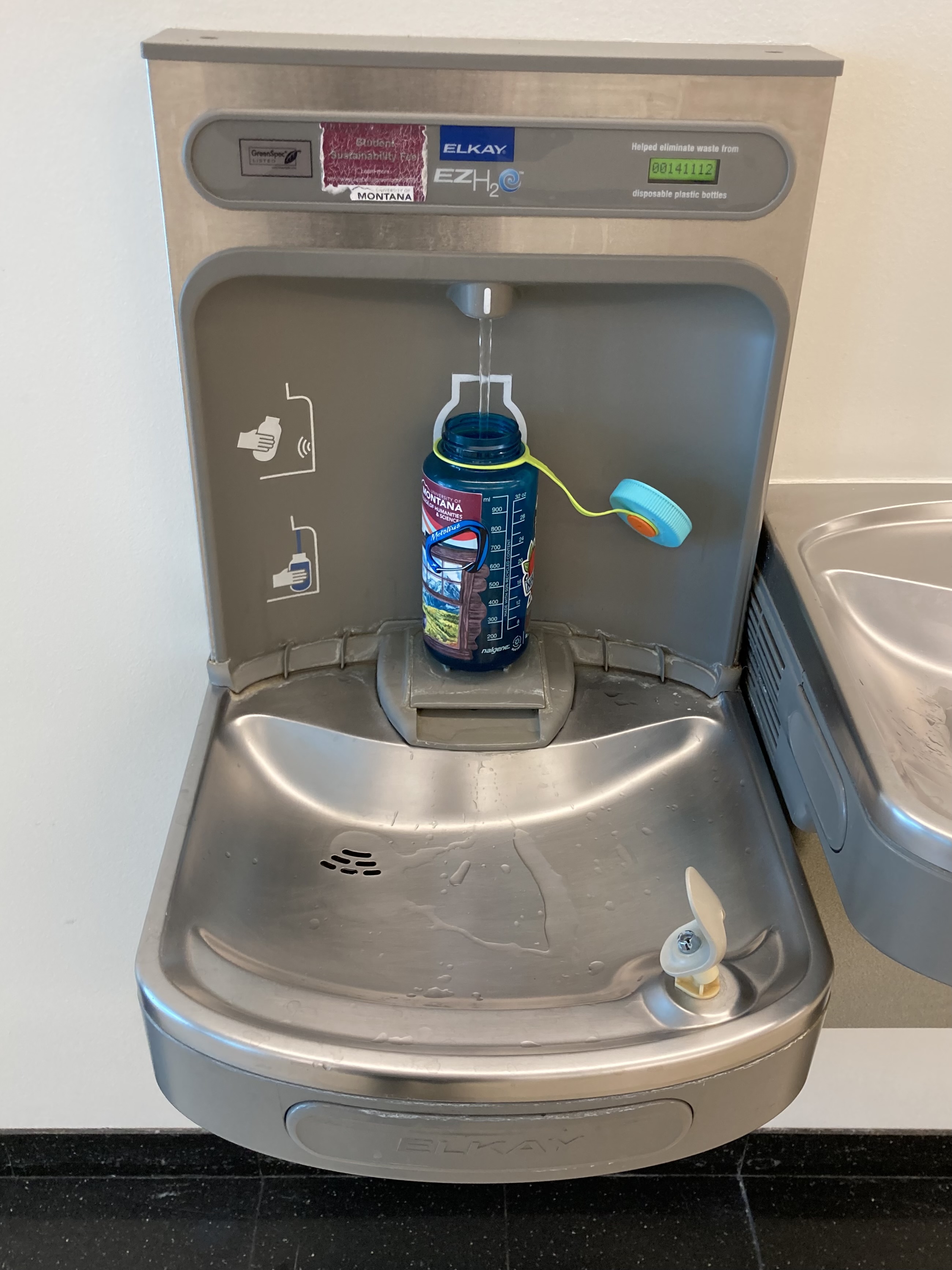 nalgene water bottle getting filled at the Gallager Business Building water bottler filler