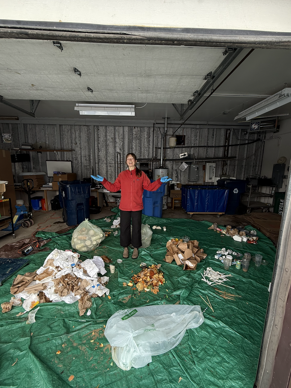 zero waste ambassador stands in sorted pile of compost