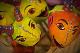 yellow and orange papier mache masks
