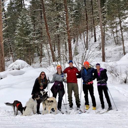 Professor Sandra Zellmer (far right) conducting “case rounds” with her clinic students Oliver Wood,  Lowell Chandler, Molly Kelly, and Molly Woodman (right to left) in the Rattlesnake Wilderness.