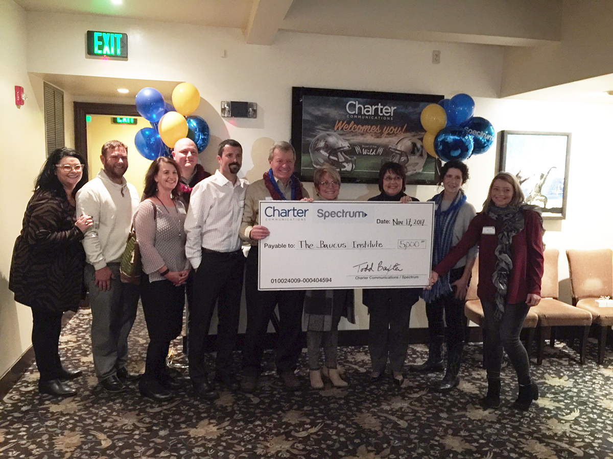 Charter Communications presents Ambassador Baucus with a check for $5,000 to support the Baucus Institute.