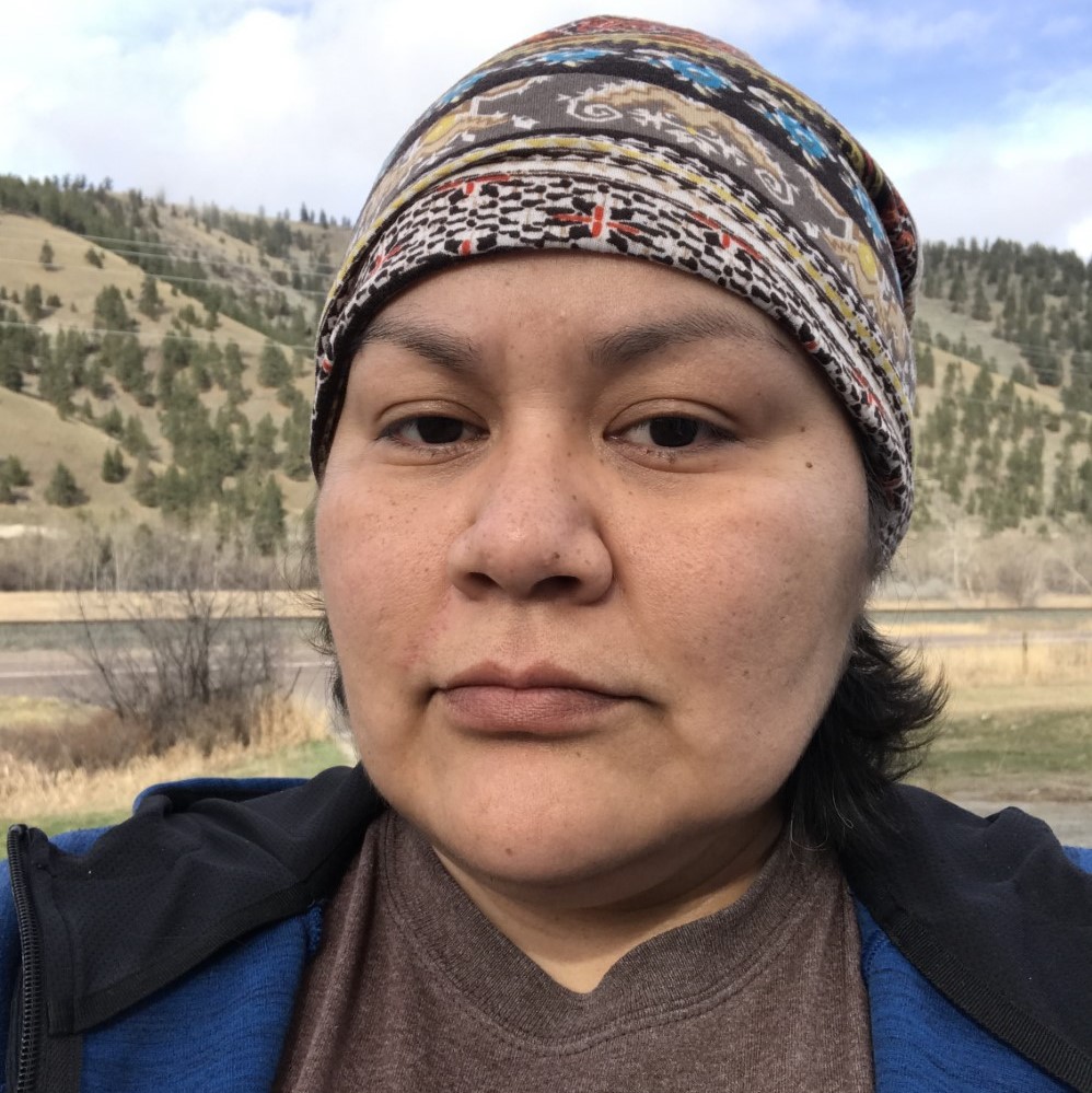 headshot of Melanie Sandoval outside with tree covered hills in the background
