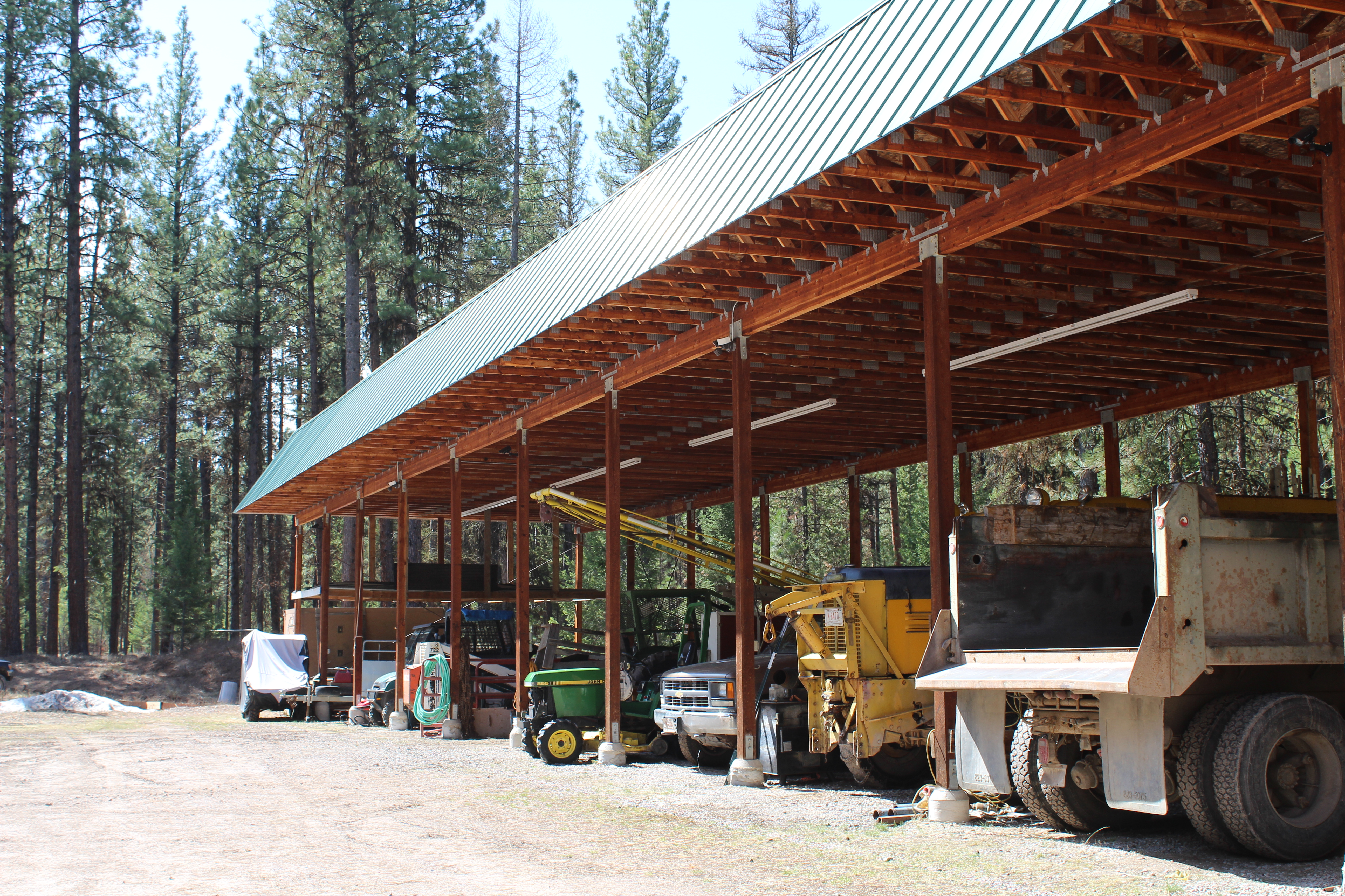 Outdoor shop containing equipment and vehicles. 