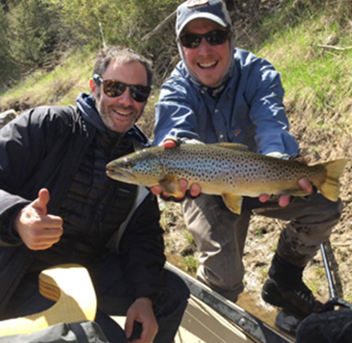 Two instructors posing with a fish
