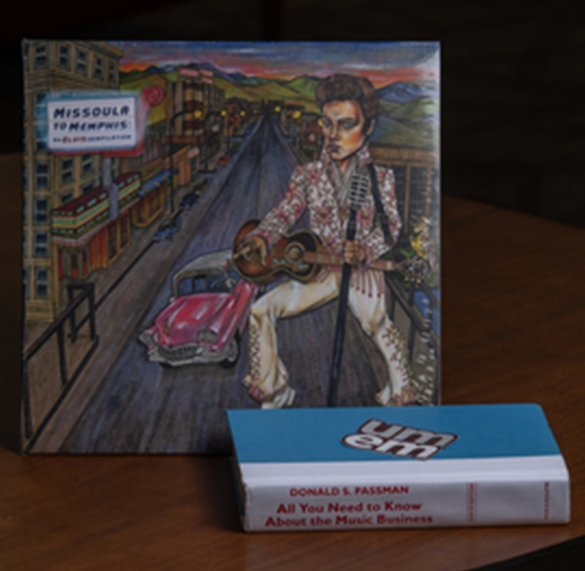 Artwork of Missoula in background with book in front titled "All You Need to Know About the Music Business" 