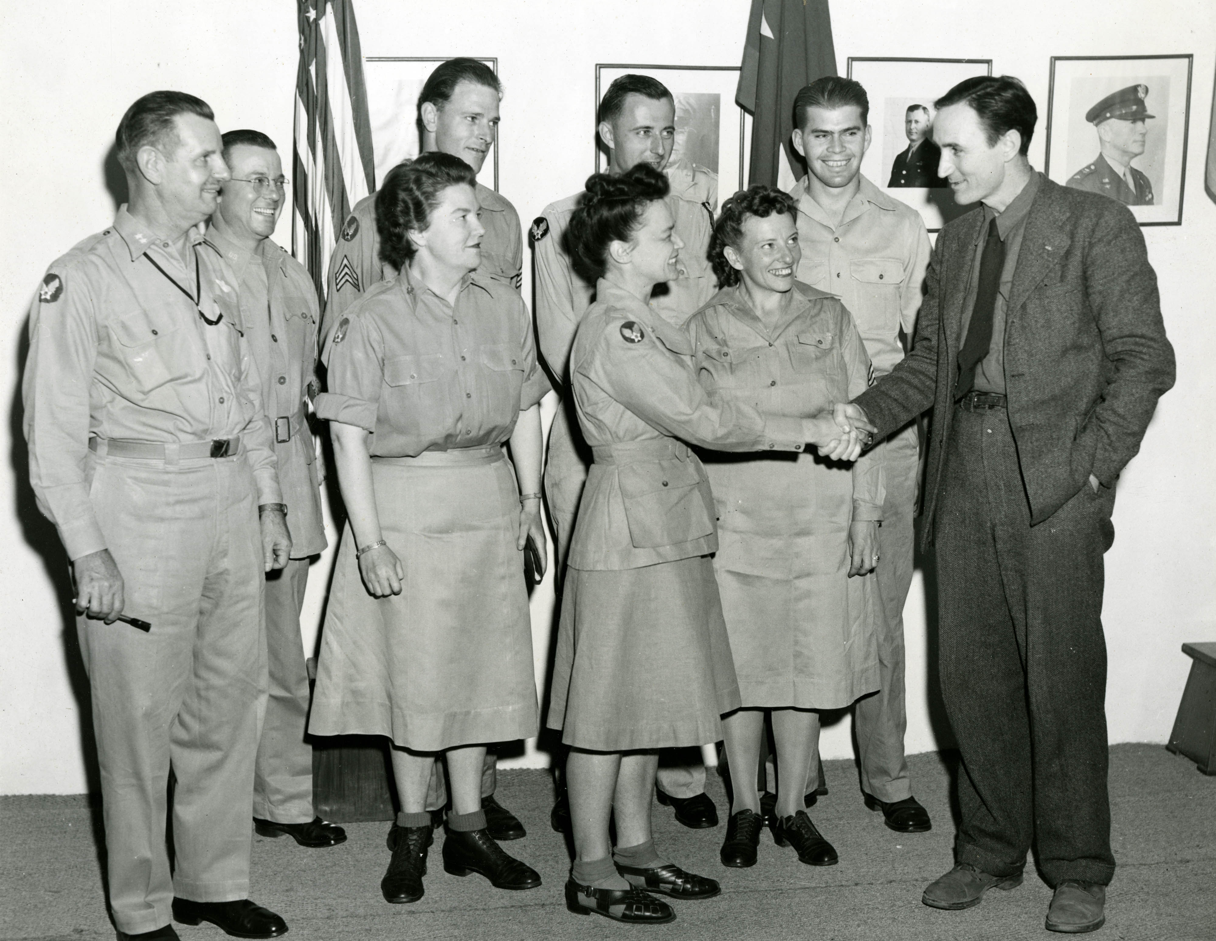 This is a photo of Mike Mansfield shaking hands with some Military folks