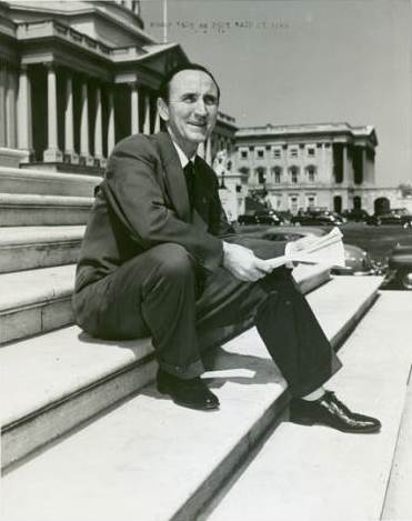 Mike Mansfield sitting on the steps of the U.S. Capitol Building