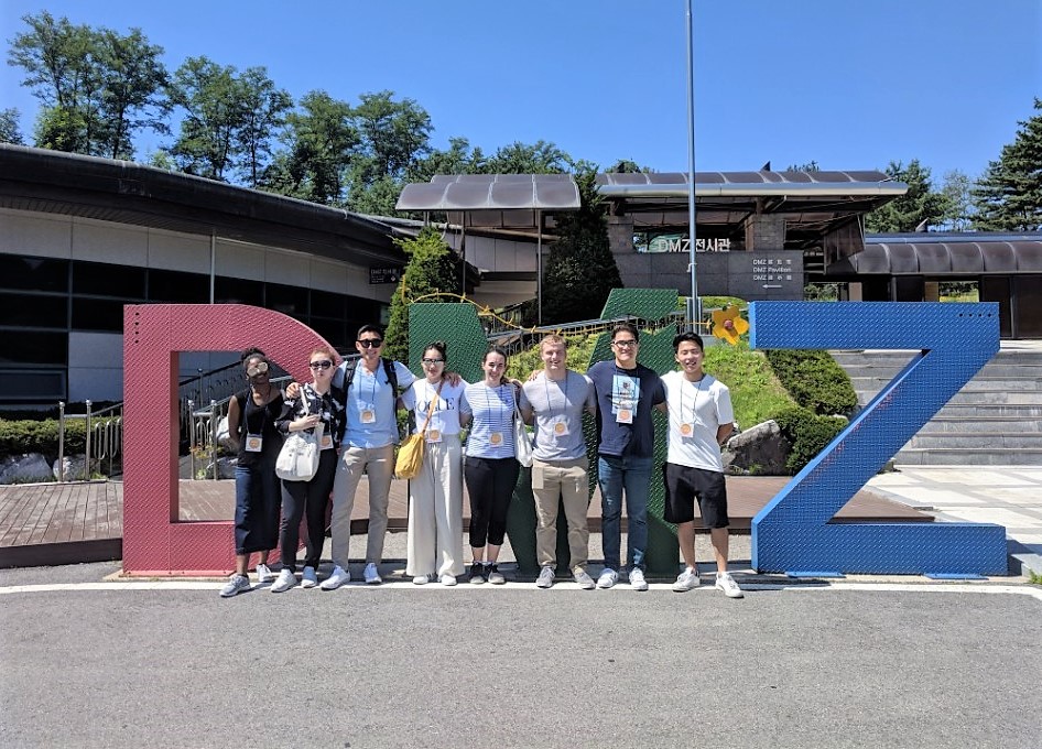 PGO Korea students stand in front of the DMZ sign in Korea.