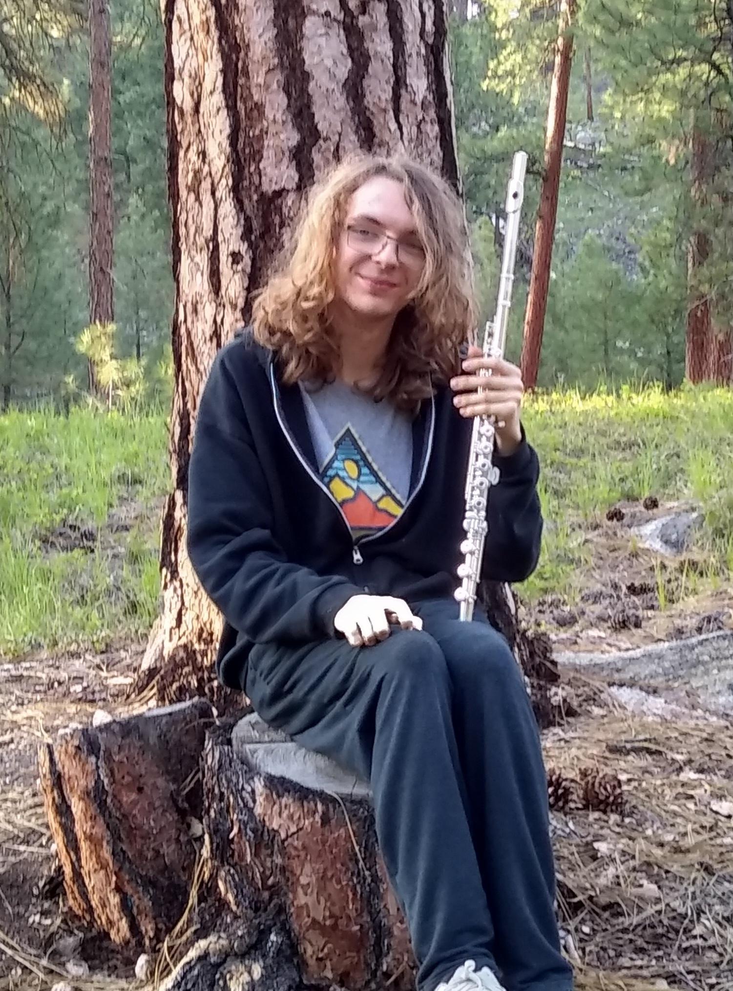 An image of Damien smiling with a flute