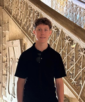 An image of Maggie Watts leaning on her hand smiling