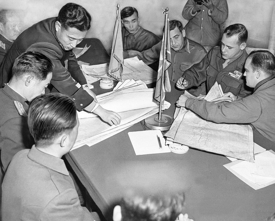 men around a table inspecting maps of demarcation zone