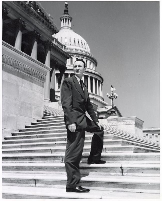 Mike Mansfield standing on the Capitol steps in a black and white image