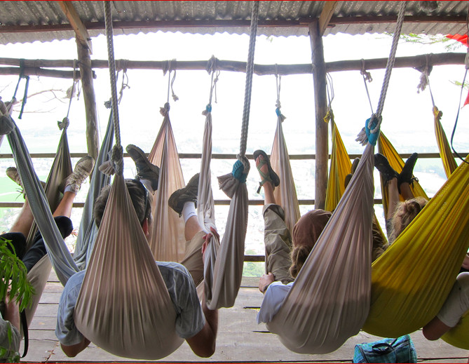 students swing in hammocks in vietnam