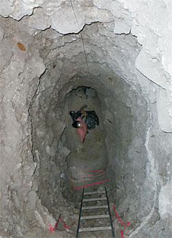 McKeown studies a tomb deep within a Mayan structure.