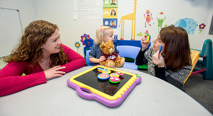 Researchers Anisa Goforth (left) and Jennifer Schoffer Closson (right), shown here in UM’s RiteCare Clinic pediatric speech therapy room, have developed an eight-week program that allows school-age kids with autism to learn social skills.