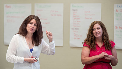 Schoffer Closson (left) and Goforth discuss their program to help students with autism, Youth Engagement Through Intervention (YETI), at an educators’ conference.