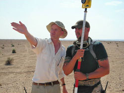 Livoti (right) and field supervisor Mark Andrew Smith work to map an Iraqi mass grave site in 2006.